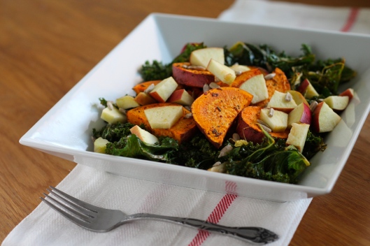 Warm roasted salad with kale, sweet potatoes, apple, and sunflower seeds